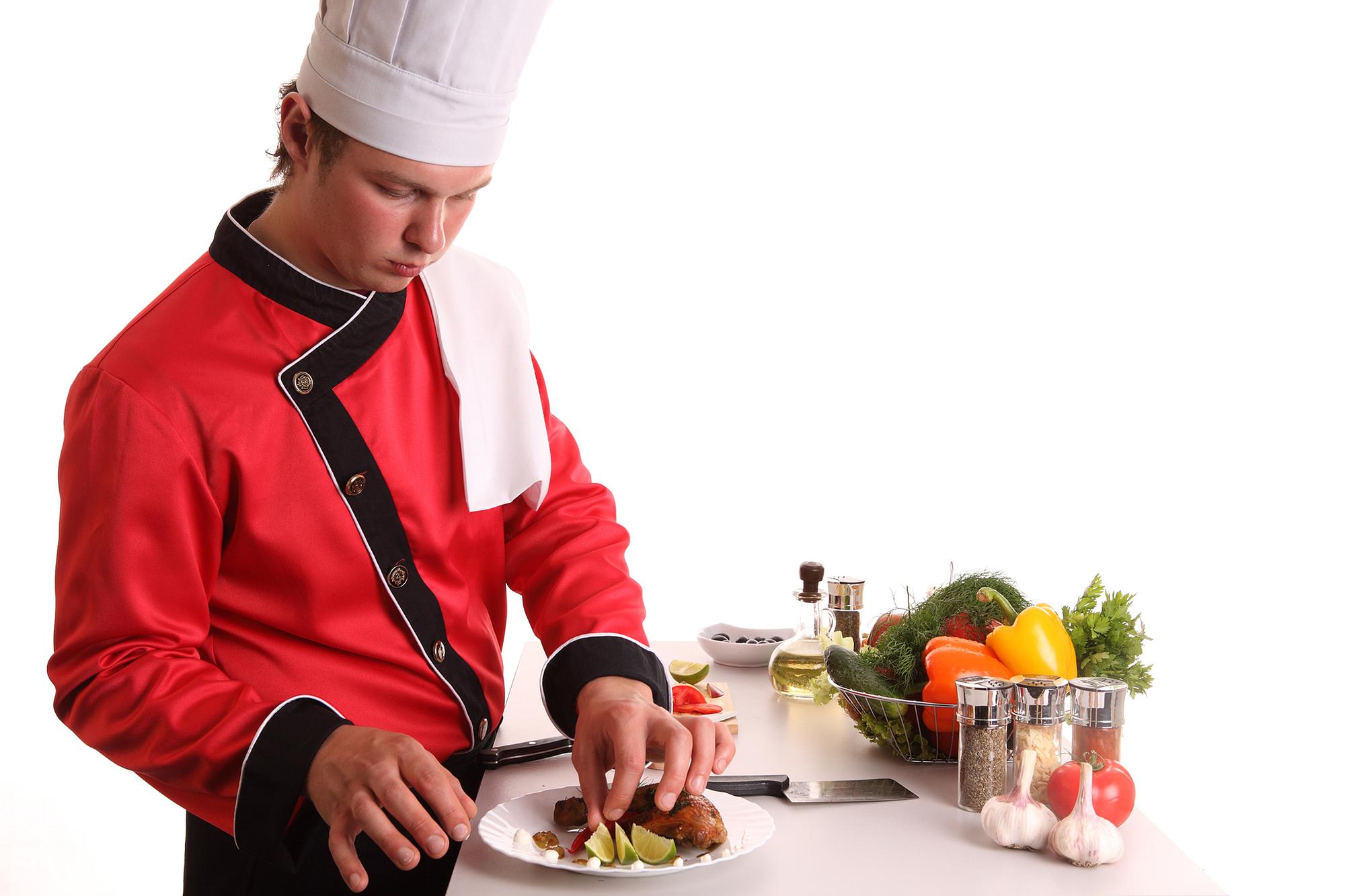 Chef demonstrating a plated dish in an online class